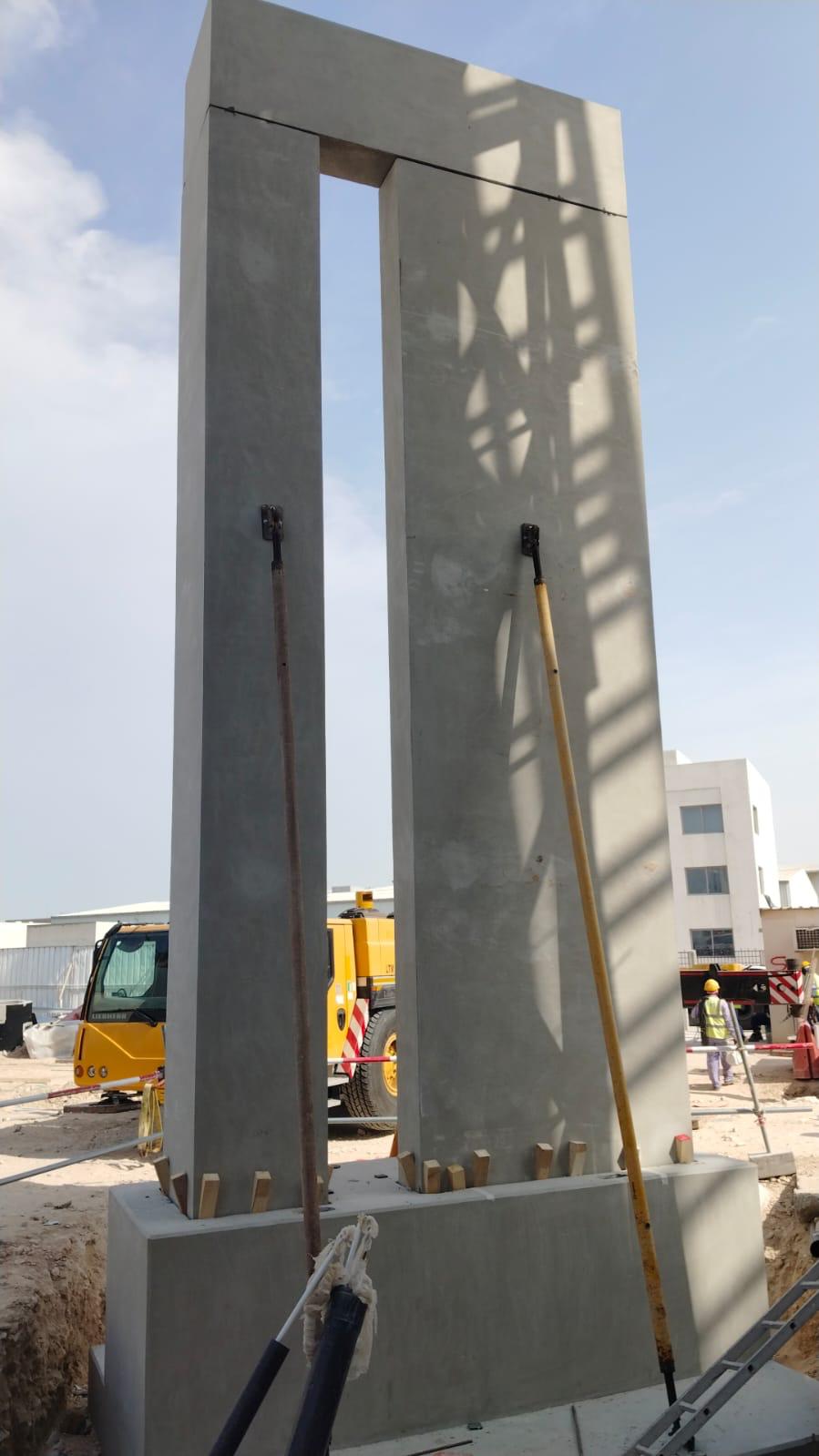 Erected precast concrete pylon with twin columns and an upper beam.